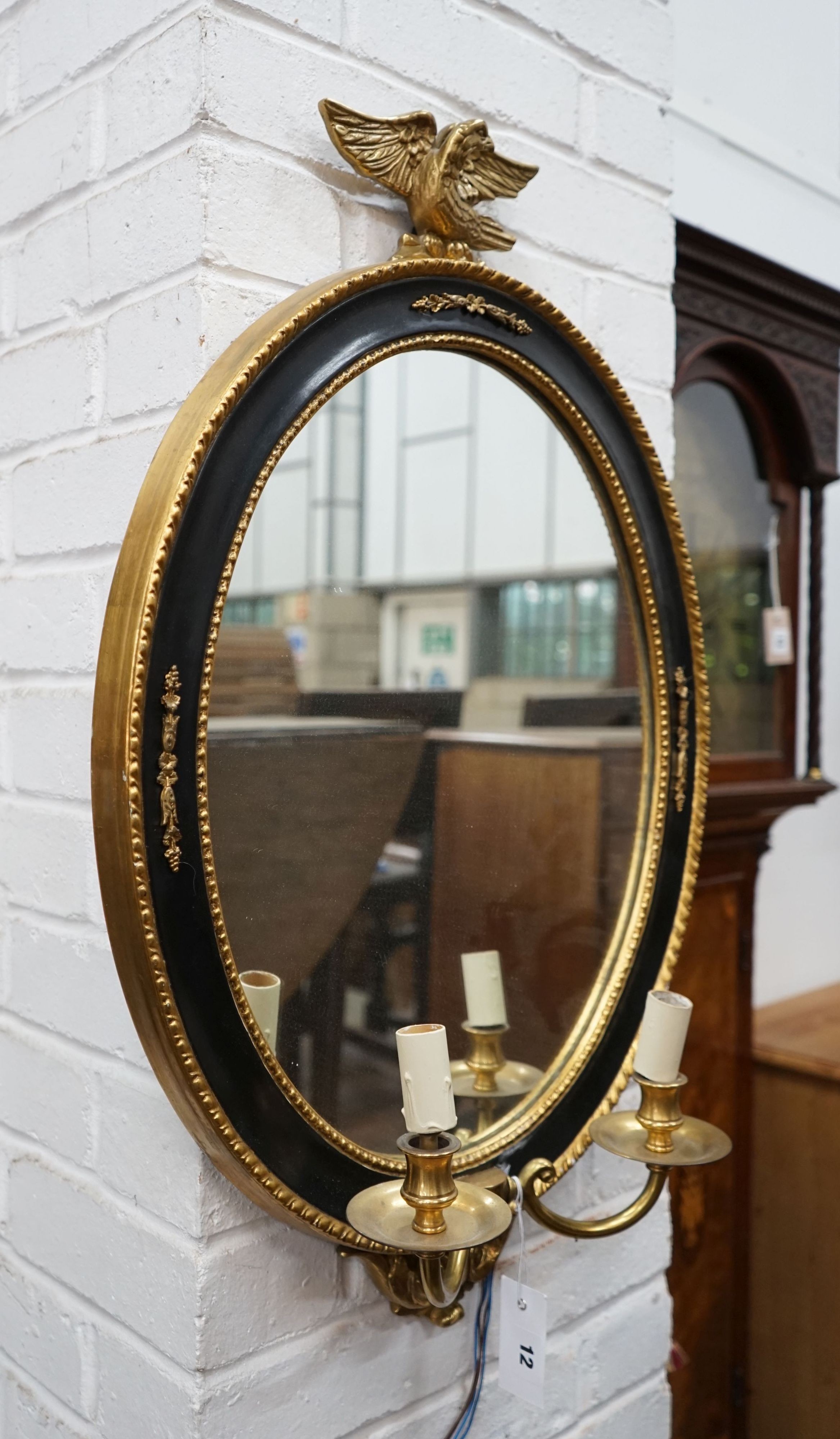 A pair of reproduction oval parcelgilt electric girandole wall mirrors, height 74cm